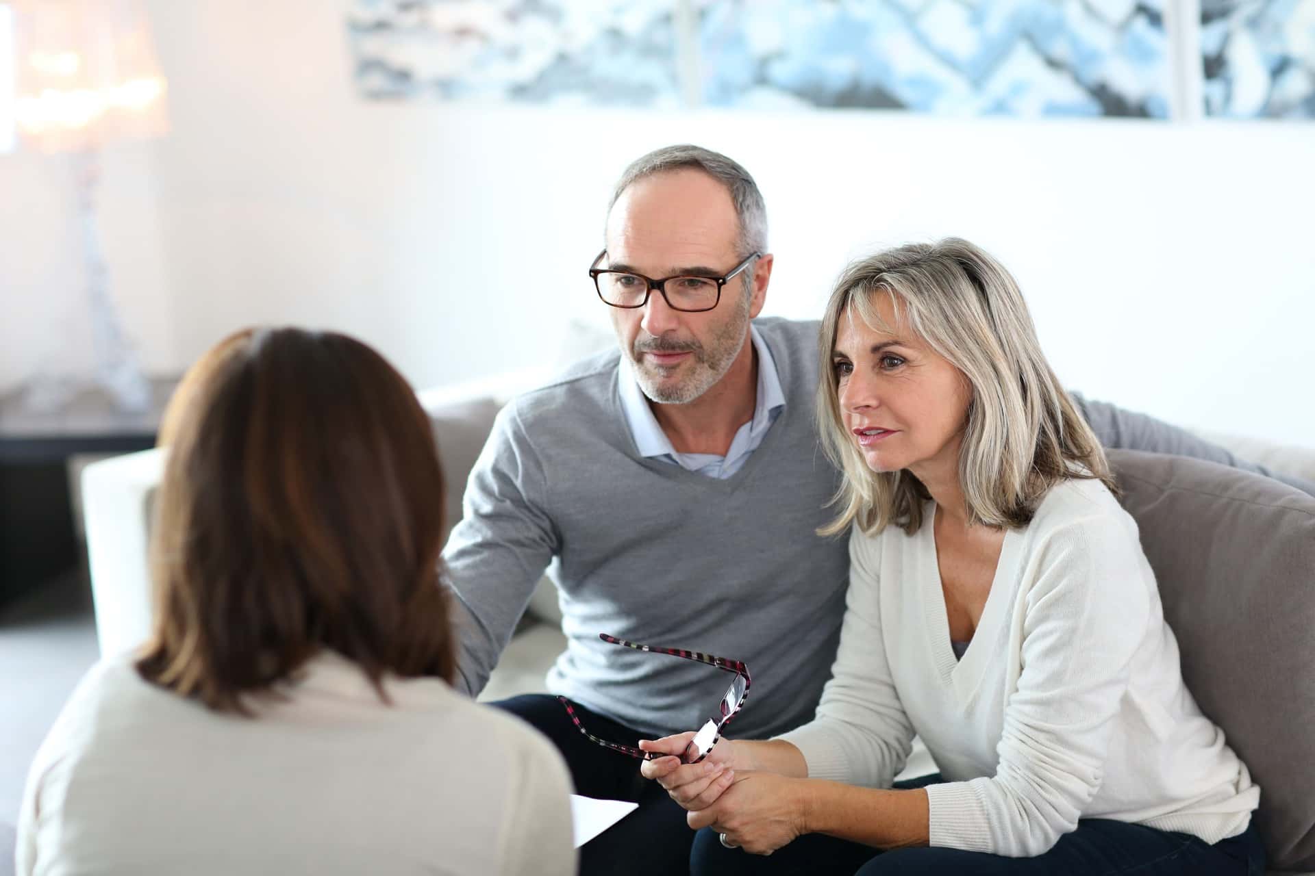 a couple listening to a financial advisor